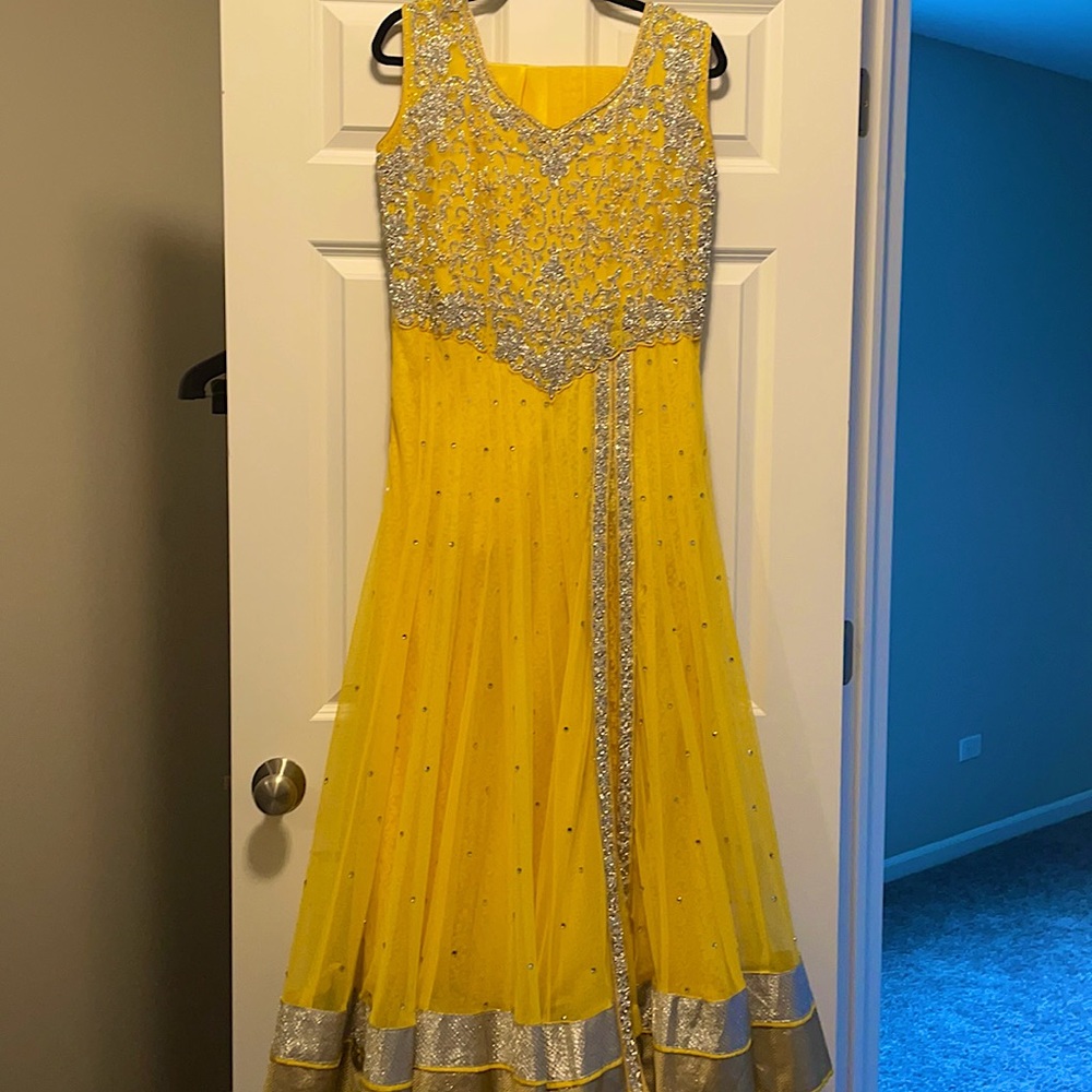 Yellow net gown with stone work.